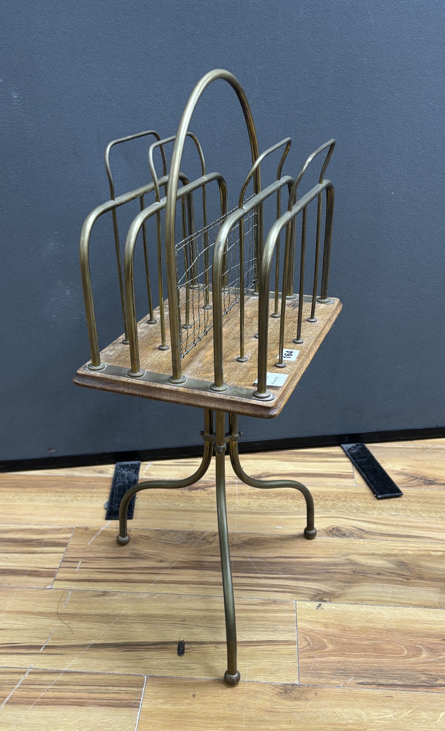 An early 20th century oak and tubular brass four division newspaper stand, height 74cm